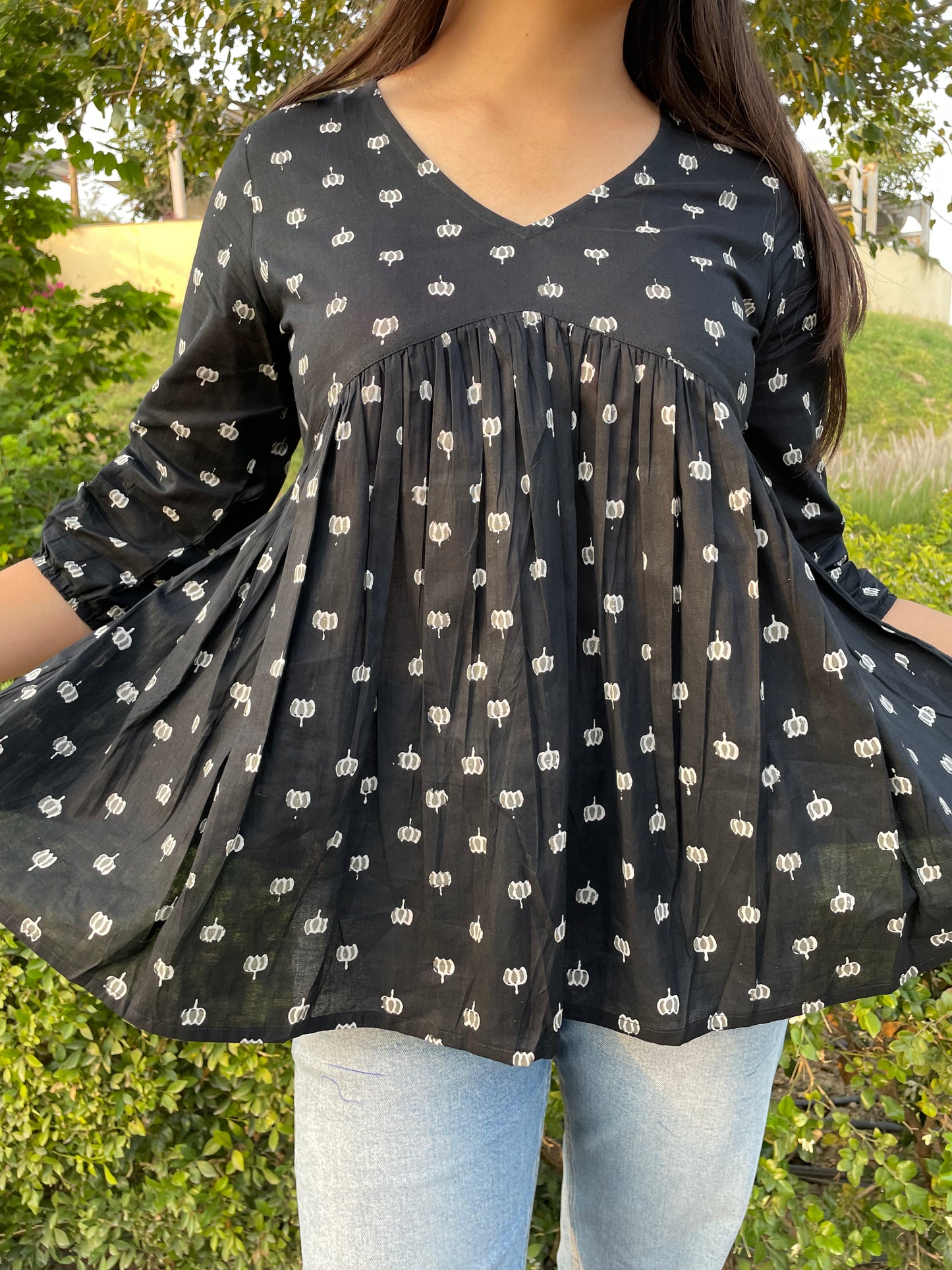 Black motif peplum top